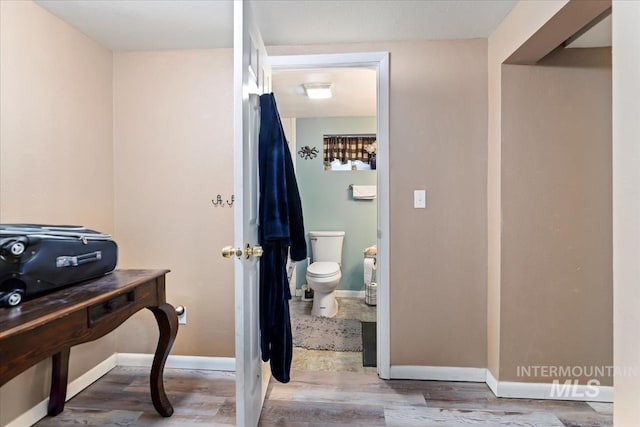 bathroom with toilet and hardwood / wood-style floors