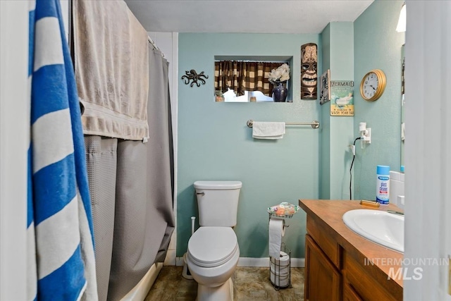 bathroom with vanity, toilet, and walk in shower