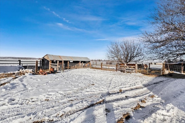 snowy yard featuring an outbuilding