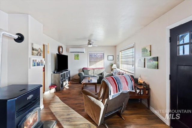 living room with dark wood-type flooring, a wall mounted air conditioner, and plenty of natural light