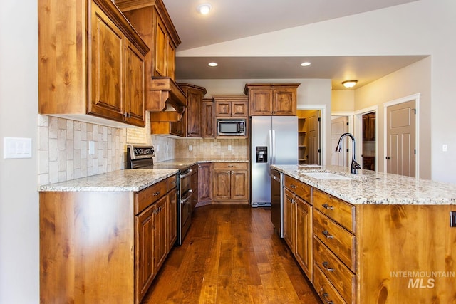 kitchen with light stone countertops, stainless steel appliances, sink, dark hardwood / wood-style floors, and lofted ceiling