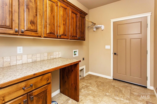 laundry area with hookup for an electric dryer, cabinets, and washer hookup