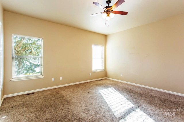 unfurnished room with carpet, plenty of natural light, and ceiling fan