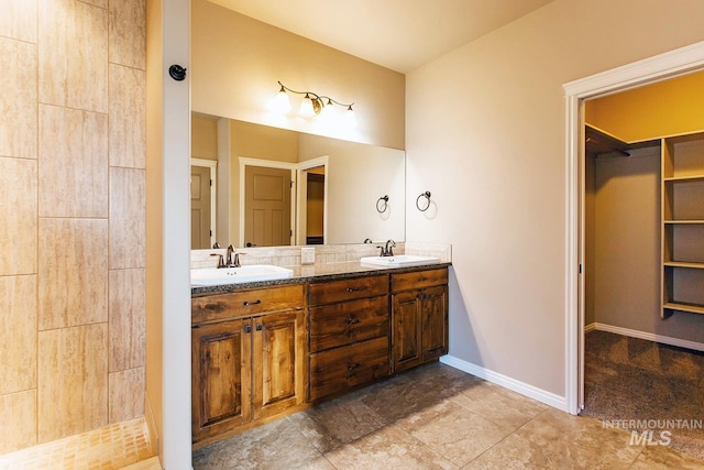 bathroom featuring a shower and vanity