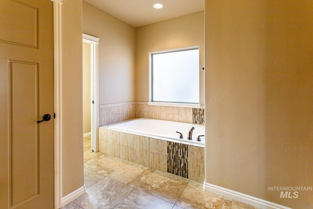 bathroom featuring tiled tub