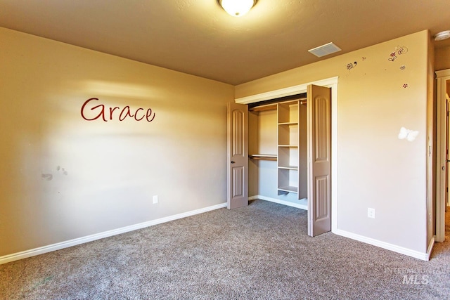 unfurnished bedroom with carpet flooring and a closet