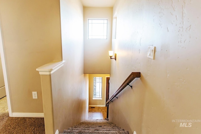 stairway featuring plenty of natural light