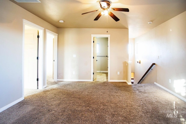 spare room featuring carpet flooring and ceiling fan