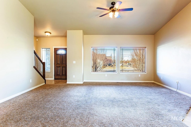 unfurnished living room featuring carpet flooring and ceiling fan