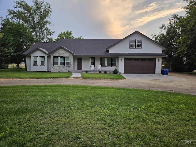 view of front of house with a front yard, driveway, and an attached garage