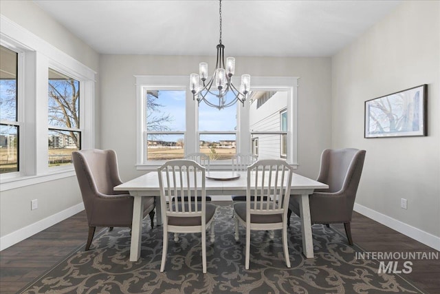 dining room with baseboards, a chandelier, and dark wood-type flooring