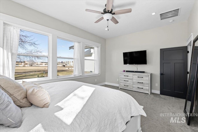 bedroom with baseboards, visible vents, ceiling fan, and carpet flooring