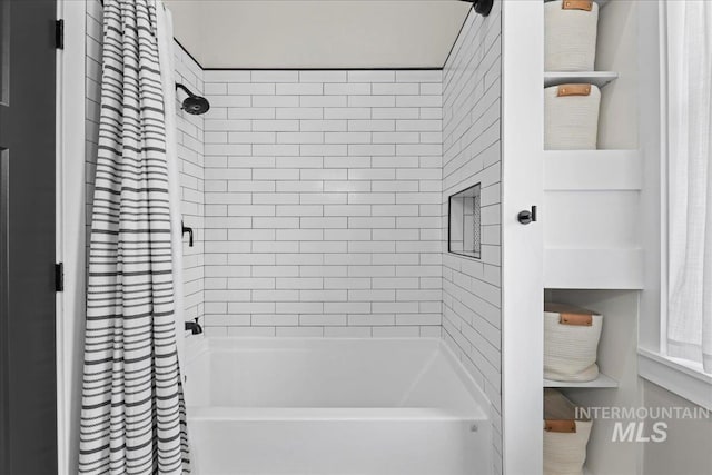 bathroom with shower / bath combo with shower curtain