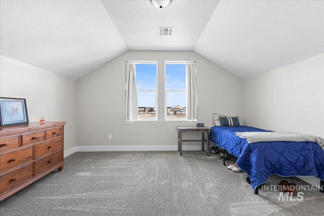 carpeted bedroom featuring a textured ceiling, vaulted ceiling, visible vents, and baseboards