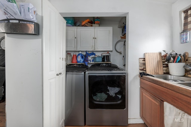 laundry room featuring cabinets and washing machine and dryer