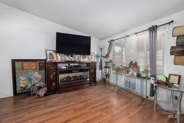 living room with hardwood / wood-style floors and vaulted ceiling