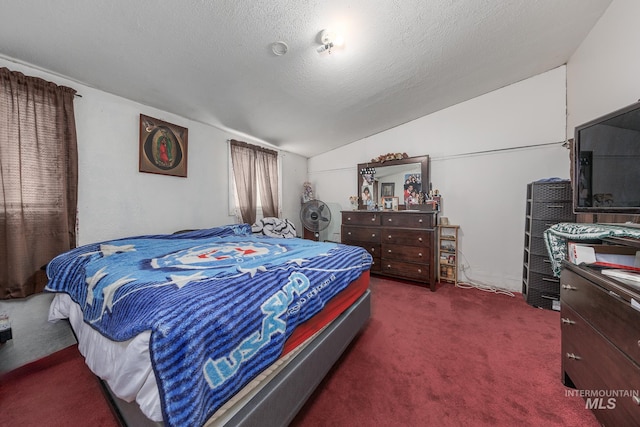 bedroom with dark carpet, a textured ceiling, and vaulted ceiling