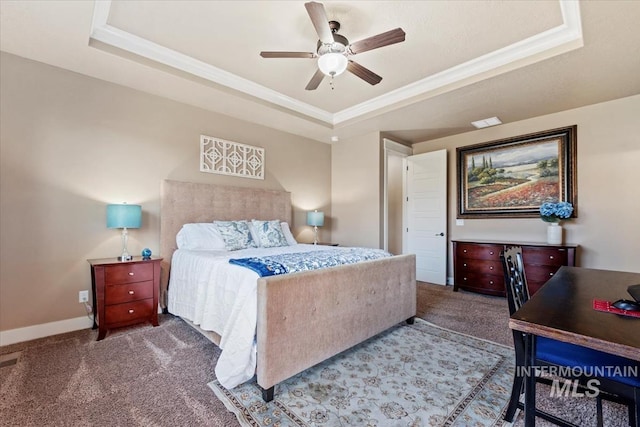 carpeted bedroom featuring baseboards, crown molding, a tray ceiling, and a ceiling fan