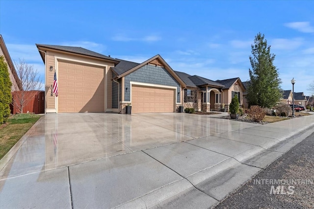 view of front of property featuring stone siding, concrete driveway, and an attached garage