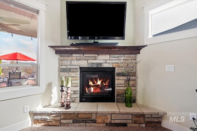 details with a stone fireplace