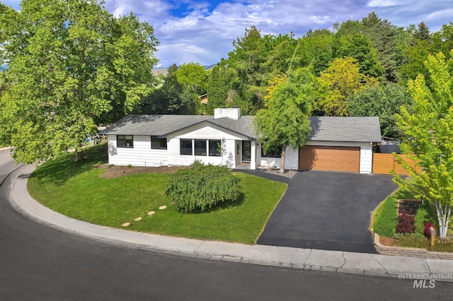 713 E Harcourt Rd, Boise, ID 83702 - ranch-style house with asphalt driveway, a garage, and a front yard