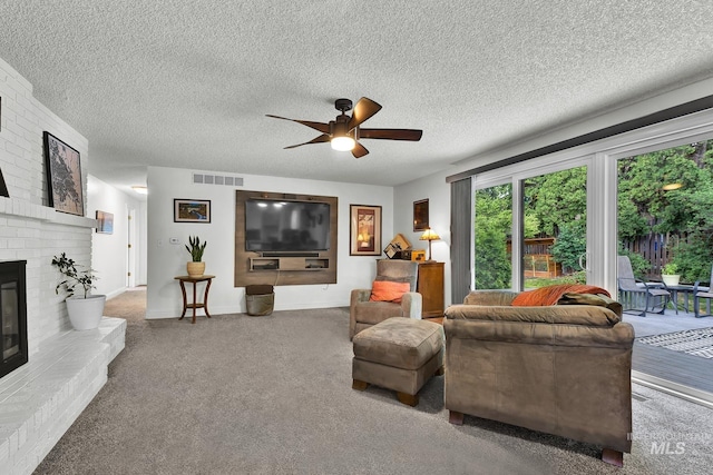 713 E Harcourt Rd, Boise, ID 83702 - living room featuring a ceiling fan, a fireplace, carpet floors, a textured ceiling, and baseboards