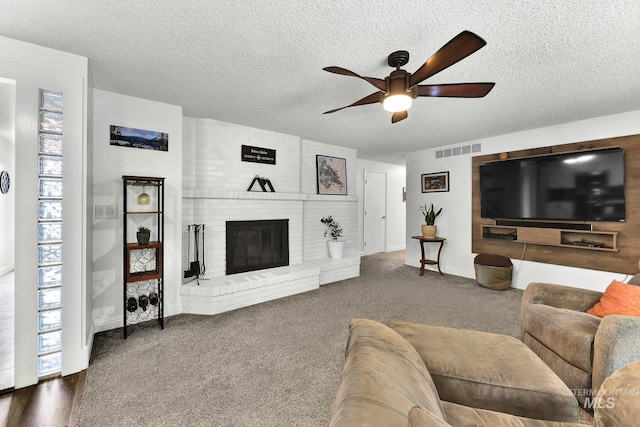 713 E Harcourt Rd, Boise, ID 83702 - living room with a ceiling fan, a textured ceiling, a fireplace, baseboards, and carpet floors