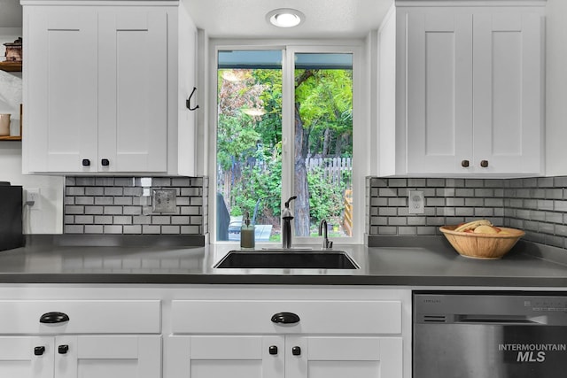 713 E Harcourt Rd, Boise, ID 83702 - kitchen featuring dishwasher, a sink, decorative backsplash, white cabinetry, and dark countertops