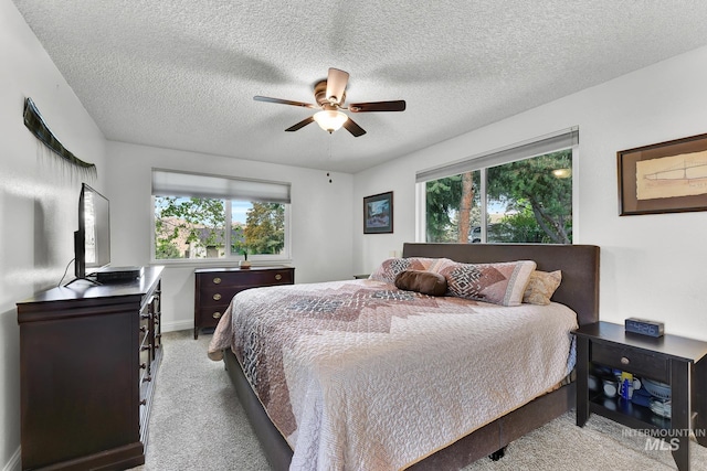 713 E Harcourt Rd, Boise, ID 83702 - bedroom with light carpet, ceiling fan, a textured ceiling, and baseboards