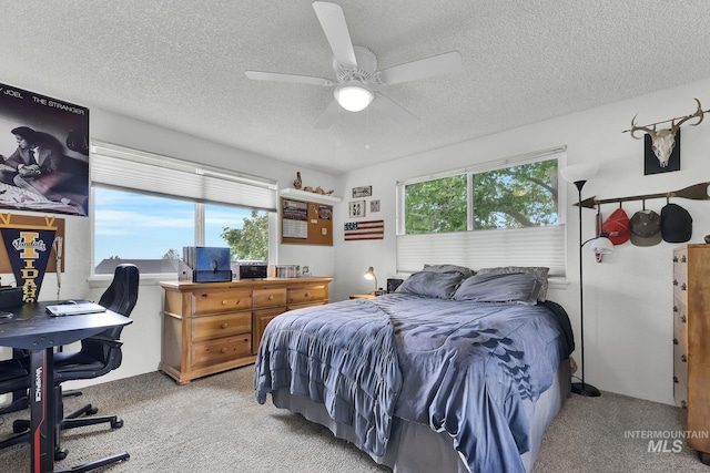 713 E Harcourt Rd, Boise, ID 83702 - bedroom featuring light colored carpet, a textured ceiling, a desk, and a ceiling fan