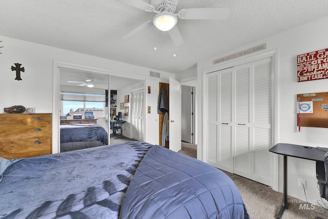713 E Harcourt Rd, Boise, ID 83702 - carpeted bedroom featuring two closets, a textured ceiling, and ceiling fan