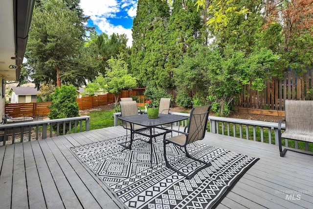 713 E Harcourt Rd, Boise, ID 83702 - wooden deck featuring outdoor dining area and a fenced backyard