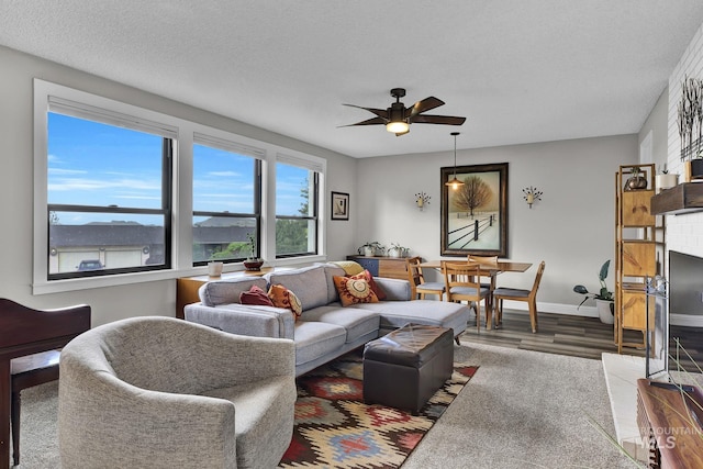 713 E Harcourt Rd, Boise, ID 83702 - living room with wood finished floors, a ceiling fan, a textured ceiling, and baseboards