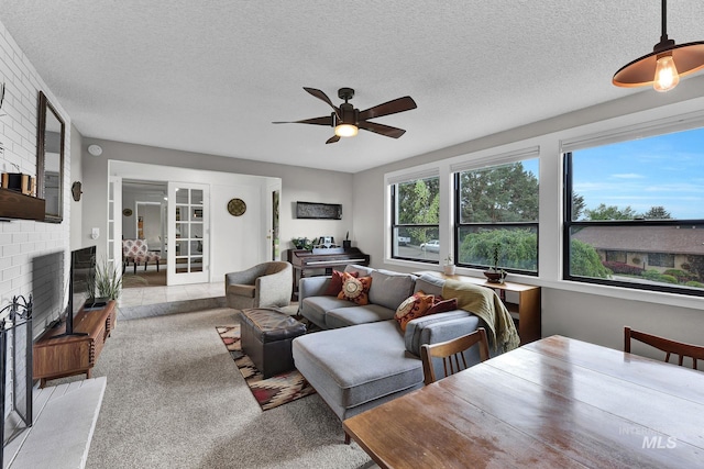 713 E Harcourt Rd, Boise, ID 83702 - carpeted living room featuring ceiling fan, a fireplace, and a textured ceiling