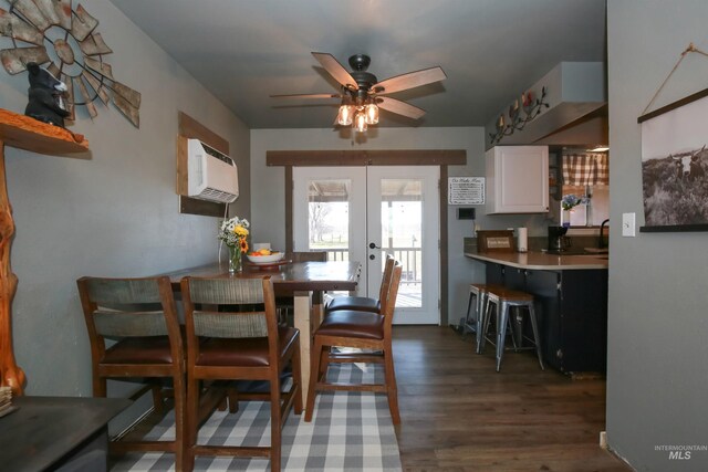 dining room with an AC wall unit, ceiling fan, dark hardwood / wood-style floors, and french doors