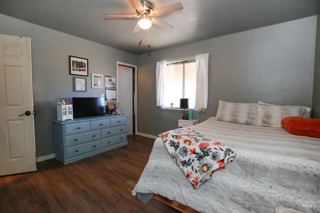 bedroom with ceiling fan and dark hardwood / wood-style flooring