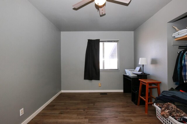 office with ceiling fan and dark hardwood / wood-style flooring