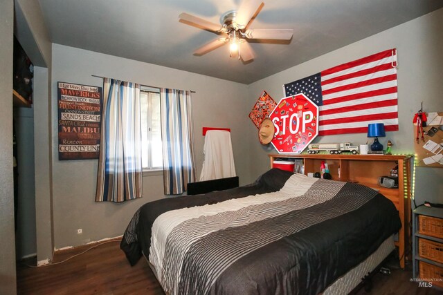 bedroom featuring ceiling fan and dark wood-type flooring