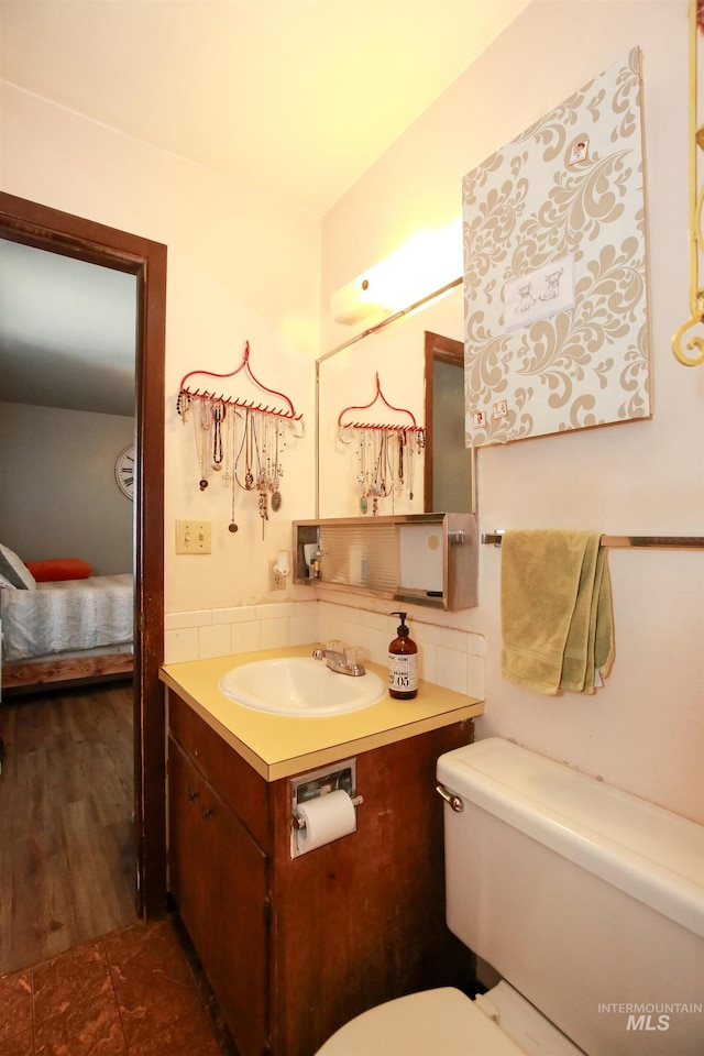 bathroom with oversized vanity, toilet, and tile flooring