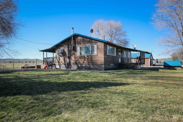 rear view of property featuring a yard