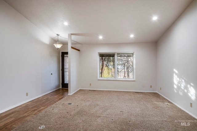 spare room with recessed lighting, baseboards, and wood finished floors