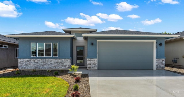 prairie-style house featuring stone siding, driveway, stucco siding, and a garage