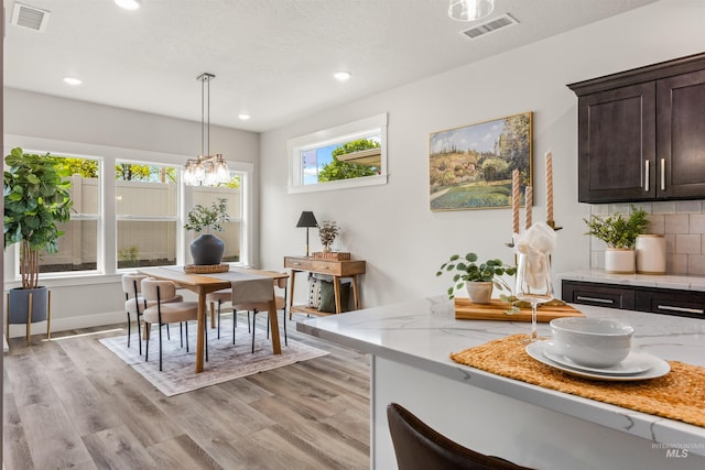dining room with light wood-style floors and recessed lighting