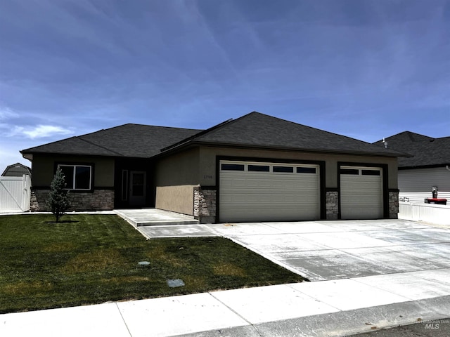 prairie-style home with a garage and a front yard