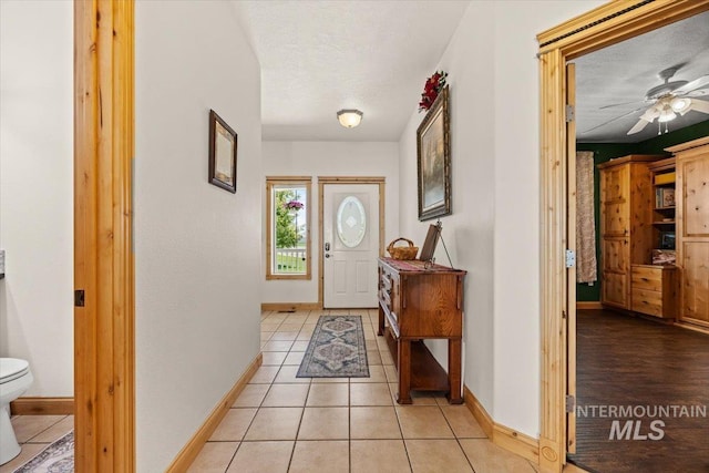 3415 Marble Front Rd, Caldwell, ID 83605 - entryway with baseboards, ceiling fan, and light tile patterned flooring