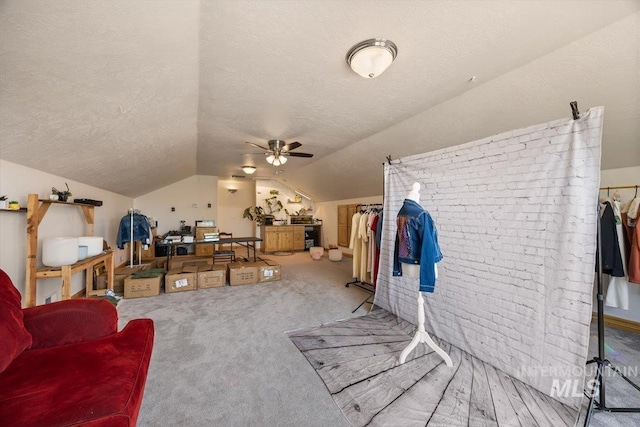 3415 Marble Front Rd, Caldwell, ID 83605 - living area featuring a textured ceiling, vaulted ceiling, ceiling fan, carpet floors, and brick wall