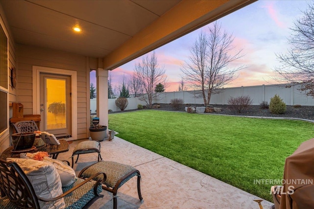 4071 S Twilight Rise Ave, Meridian, ID 83642 - patio terrace at dusk featuring a patio, a fenced backyard, and a grill