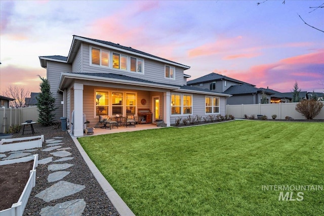 4071 S Twilight Rise Ave, Meridian, ID 83642 - back of house at dusk featuring a fenced backyard and a patio area