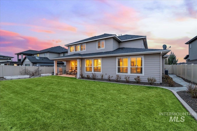 4071 S Twilight Rise Ave, Meridian, ID 83642 - back of property at dusk featuring a patio area, a fenced backyard, and roof with shingles