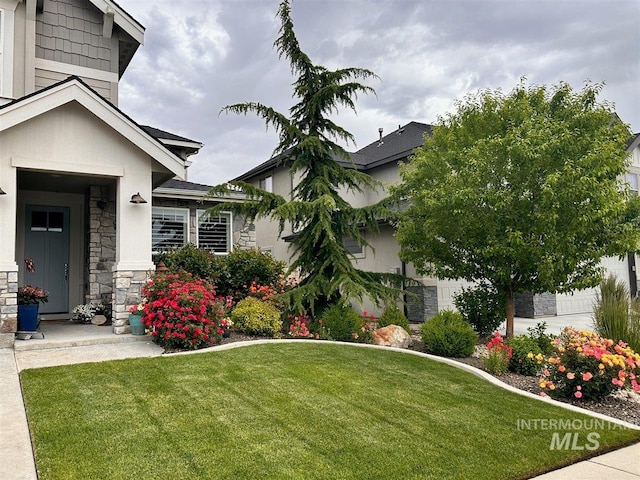 4071 S Twilight Rise Ave, Meridian, ID 83642 - view of front facade with stone siding and a front lawn